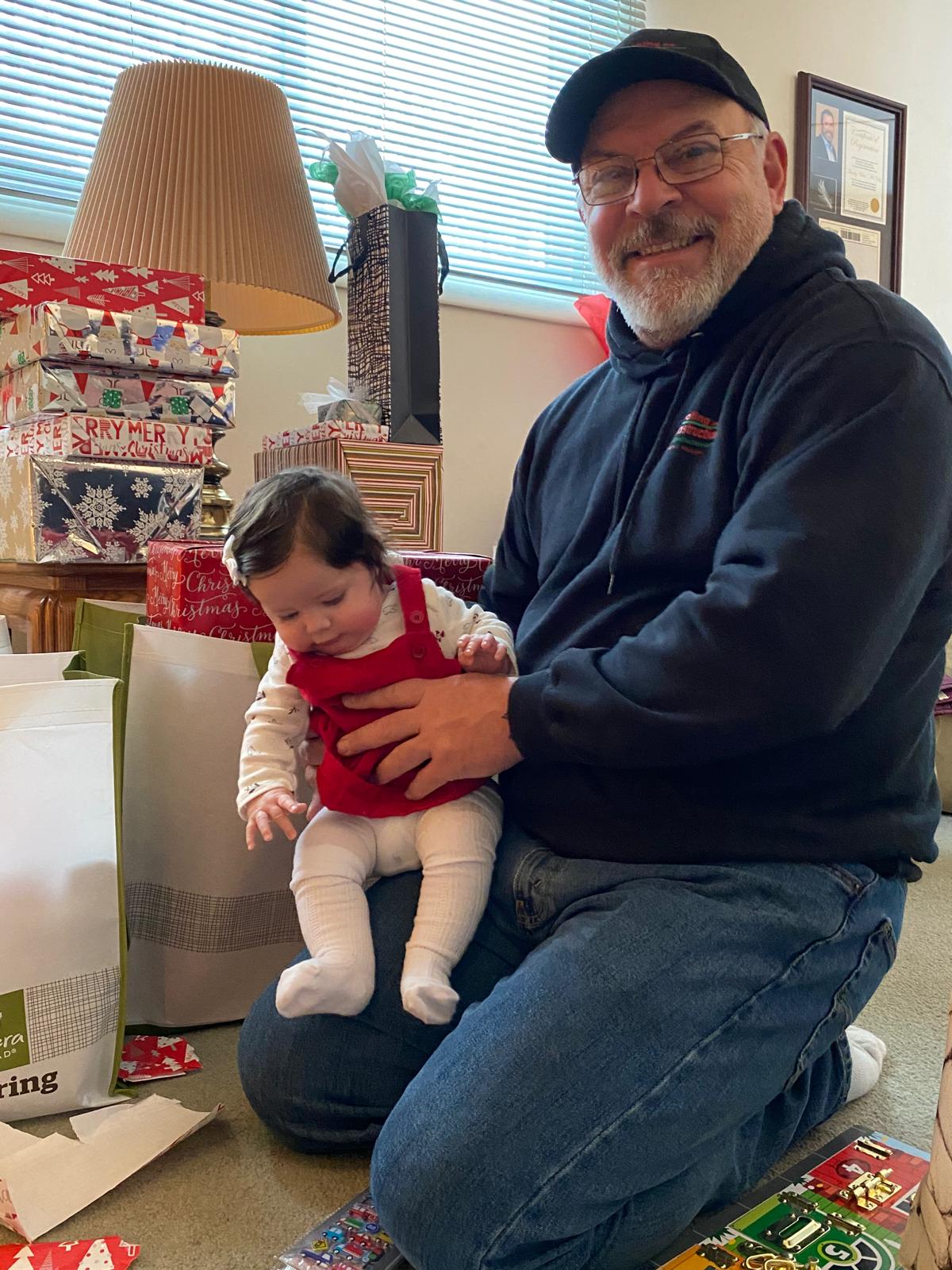 Dave weinbrecht from dw Roofing holding a baby